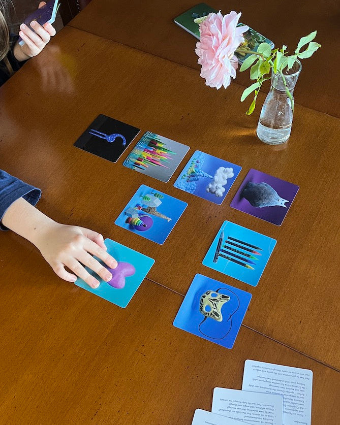 Emotion cards on a table used by parent and child to talk about their day through play.