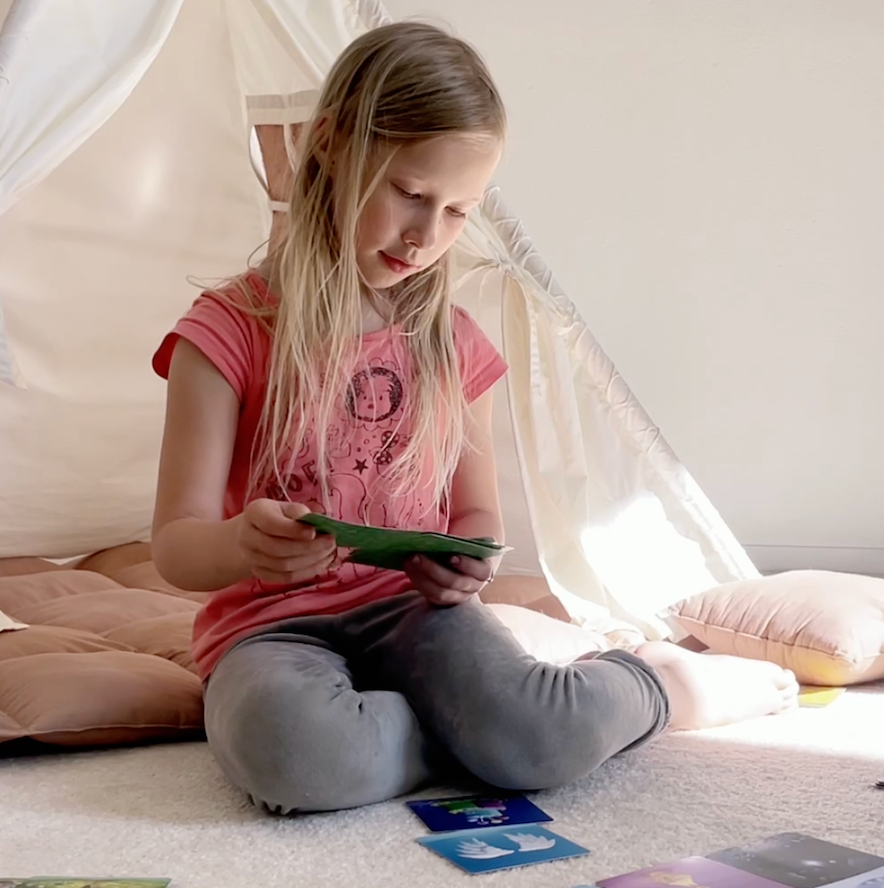 Cards laid out during a calm evening moment, encouraging short, meaningful conversations between parents and children as part of a bedtime routine.