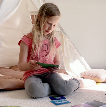 Cards laid out during a calm evening moment, encouraging short, meaningful conversations between parents and children as part of a bedtime routine.